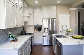After slightly distressing these white kitchen cabinets, the design team at frankel building group applied an antique glaze. Colonial Ii Maple Bright White Brushed Gray Glaze Framed Cabinets Trim Details Onlays Cabinets Com