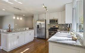 Hdf framed door with raised hdf center panel; How Do You Like This Open Kitchen Design With Quartz Counters Glass Tile Back Splash Coastal Vi Cost Of Kitchen Cabinets Kitchen Design Open White Cabinets