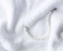 If your pearls are visibly stained, you can mix a solution of lukewarm water and mild dish soap, dip a soft cleaning cloth in it and wipe the pearls. How To Gently Clean Pearl Jewelry