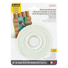 A butter knife, plastic spatula or credit card works well and doesn't damage the wall. Scotch Foam Mounting Tape