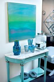 Chic Foyer Features Turquoise Blue Abstract Art Over Turquoise Console Table Topped With White Marb Turquoise Table Marble Top Console Table Blue Console Table