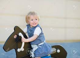 Baby Swing On Horse On Playground And Looking On Copy Space Stock Photo Picture And Royalty Free Image Image 14031186