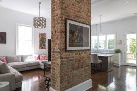 A Red Brick Column Makes A Stately Anchor In This Open Concept Living Space Polished Hardwood Brick Columns Open Plan Living Room Brick Living Room