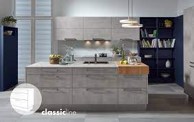 The arched structure concealing the oven hood is a brilliant shade of red. Pronorm Einbaukuchen