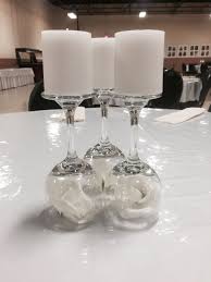 If your kitchen is small and you have to make due with open storage, this glasses holder can serve as a means to keep the cluttered look. Diy Table Centerpieces Wine Glasses With Flower Bud Underneath Votive Candles On Top 50th Wine Glass Candle Holder Wine Glass Candle Table Centerpieces Diy