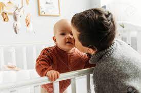 A Big Brother Is Lovingly Hugging His Newborn Baby Sister As They Lay In Bed Together Stock Photo Picture And Royalty Free Image Image 143818691