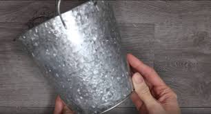 With the black paint pen (so much easier than using a small black paint brush) outline the embossed letters on both sides of container. Dollar Store Easter Decorations Easy Diy Crafts How To Make Bunny Flower Pot Centerpiece Simple Decor Ideas For The Home Dollar Tree Hacks