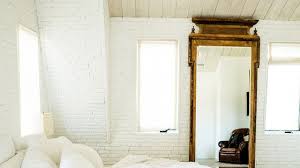 Another example of a brick interior wall with gray paint, white trim and a really nice white washed hardwood floor. Painted Brick Wall Ideas And Inspiration Architectural Digest