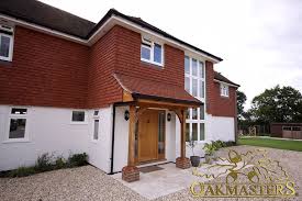 Small oak porch with a king post truss and red tiled roof (5434) oak porch with raised tie truss (5992) open oak porch adds character to a modern brick house (5993) traditional oak porch on a small brick cottage (5429) wide timber porch (5423) welcoming oak porch with uncomplicated design (5424) large oak porch (5417) open oak porch with overhang (5418) oak porch supporting the floor above (5419) Open Porches Oakmasters