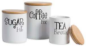 3 black canisters with coffee, sugar, and tea writing prints on the exterior. White Coffee Sugar Tea Ceramic Canister Set Of 3 Contemporary Kitchen Canisters And Jars By Design Imports Houzz