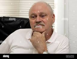 Lawyer Hans Bauer, chairman of the society for legal and humanitarian  support and former East German deputy Attorney General gestures as he  explains the aims of the association in his Berlin office