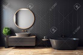 Contrast a black clawfoot tub with a white vanity and use black and white floor tile. Modern Black Bathroom Interior With Decorative Tree Bath Tub Stock Photo Picture And Royalty Free Image Image 119371047