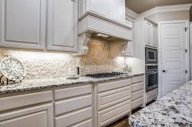 A minimalist grey kitchen with a navy hood, wooden shelves and a white stacked. Stacked Stone Design Ideas Designing Idea