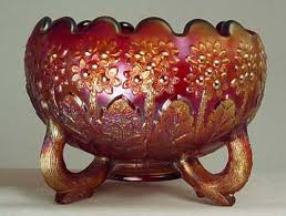 This pattern has a small peacock flanked by a tall plant with large leaves. Fenton Carnival Old And New Carnival Glass Worldwide