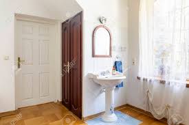 Maybe you would like to learn more about one of these? Real Photo Of A Classic Bedroom Interior With Doors Wash Basin Mirror And Window Decorated With Curtains Stock Photo Picture And Royalty Free Image Image 105924462