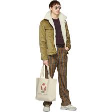 Black cotton corduroy trucker jacket from maison kitsuné featuring corduroy, faux shearling lining, contrasting collar, snap fastening, long sleeves and two front flap pockets. Maison Kitsune Tan Corduroy Trucker Jacket Maison Kitsune