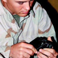 US Marine Corps (USMC) Private First Class (PFC) Colby Archer, 3rd Light  Armored Reconnaissance Battalion, Twentynine Palms, California (CA), plays  a game of casino with his time off at Camp Ripper, Kuwait,