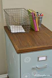 Then, pour a small amount into a paint tray, load up the foam roller and begin to paint the outside frame of the filing cabinet. Wood Trimmed Filing Cabinet Makeover H2obungalow