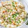 In a large bowl, add the cooked and cooled pasta, tuna, celery, green onions, peas, red onion, dill, parsley and parmesan. 3