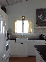 proper curtain placement above kitchen sink
