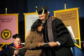 A Graduate Hugs E Timothy Moore A Retired Professor From The Pan African Studies Department During Commencement Exerc College Experience In This Moment Photo