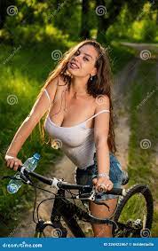 Young Woman with Big Breasts Rides a Bicycle in the Forest on a Hot Summer  Day Stock Image - Image of park, nature: 224422467