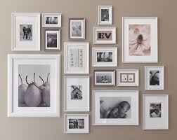 A Wall Decorated With White And Silver Coloured Picture Frames In Different Sizes Shown Together With F Gallery Wall Frames Picture Frame Wall Frames On Wall