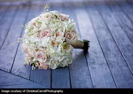 Use golden yellow as the star or an accent in your wedding bouquet, with flowers such as roses, dahlias, sunflowers, and ranunculus. The Bridal Bouquet Will Be A Clutch Of Cream Hydrangeas Pale Pink Roses Stephanotis With Pearls And Whit Bridesmaid Flowers Romantic Bouquet Wedding Flowers