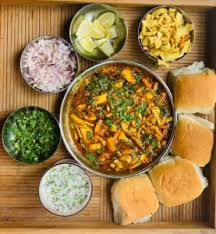 Misal pav is a vibrant meal consisting of a spicy sprouted bean curry topped with crunchy farsan, crisp red onions and fresh cilantro that is served with lightly buttered pav or dinner rolls. Misal Pav By Madhuri Adhalrao Gossip About Food