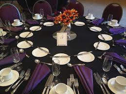 A Unique Wedding Black Tablecloths And Dark Purple Napkins Complemented With Orange Centerpieces Purple Table Settings Purple Tablecloth Table Runners Wedding