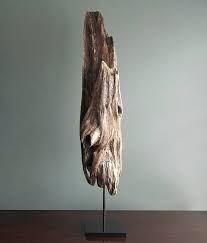 Her face is made from clay sculpted directly into the driftwood. Driftwood Sculpture Zenith With Metal Stand Etsy Driftwood Sculpture Sculpture Metal Stand