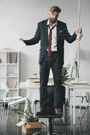 His chair was by the fireplace. Young Businessman Standing On Chair With Noose Stock Photo Dissolve