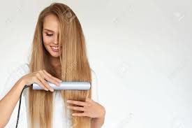 It is a good idea to add the serum while your hair is wet because then it is able to spread evenly into your hair without clumping the chair. Hairdressing Woman With Beautiful Long Straight Hair Using Hair Straightener Gorgeous Smiling Girl Straightening Healthy Blonde Hair With Flat Iron Hair Ironing Hairstyle Concept High Resolution Stock Photo Picture And Royalty Free