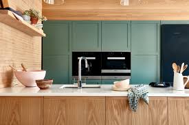Woman pulls out her favourite cabinet finish. Cabinet Finishes Naked Kitchens