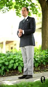 Light brown coat and white shirt underneath with black jeans and also black bag. The Blazer Guide