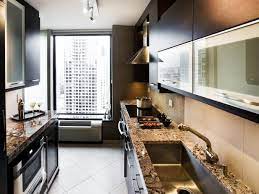 Long red galley kitchen with red and orange tile backsplash and stainless steel appliances all under a white ceiling with large wood beams. Small Galley Kitchen Ideas Pictures Tips From Hgtv Hgtv