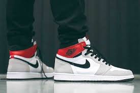 The black / black mids stand out against the light grey gravel ground and gold joggers. Air Jordan 1 Sneaker Freaker