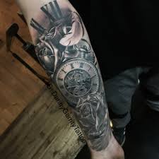 It showcases a forest of solid black pine trees circling around the lower arm. Tattoos For Men Arm Tribal