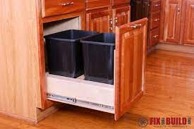 The problem with a regular cabinet is it takes multiple movements to open, and you have to use your foot or pull on the trash can to slide them out. Diy Pull Out Trash Can Fixthisbuildthat Kitchen Cabinet Plans Kitchen Cabinets Upgrade Trash Can Cabinet