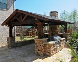 If you're in full sun, arbors or thatched roofs can be outfitted. Rustic Cedar Gable Outdoor Kitchen Rustic Outdoor Kitchens Covered Outdoor Kitchens Outdoor Pavillion