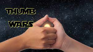 Two small children, one a small black hat, sitting among their toys are playing thumb war. Thumb Fighter 1 2 3 4 We Declare A Thumb War Youtube
