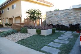 Tree Aloes Purple Aeoniums Blue Senecio And Other Succulents Help Fill In The Front Yard Landscaping By Second Nature Garden Design Garden Design Succulents