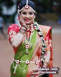 The pregnant lady is adorned with the fresh flower jewellery and garland. Artificial Flower Jewellery Online Floral Jewellery Nandini