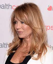 Medium wavy cut with bangs. Goldie Hawn Long Straight Copper Blonde Hairstyle With Layered Bangs