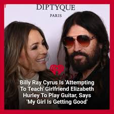 My patient boyfriend is attempting to teach me the guitar ❤️❤️❤️,"  Elizabeth Hurley shared