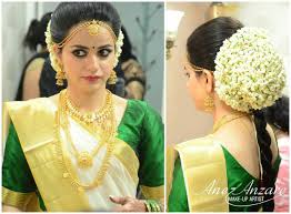 What A Beautiful Large Low Bun Covered With Flowers Care However Should Be Taken Be Hairstyles Kerala Indian Bridal Hairstyles Bridal Hairstyle Indian Wedding