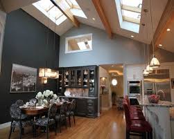 Vaulted ceilings bring a sense of openness to a home. Vaulted Ceiling With Lighting Over The Dining Room Table How To Choose Lighting Vaulted Ceiling Lighting Vaulted Ceiling Kitchen Rooms With Slanted Ceilings