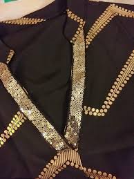 Women's black dress with gold accent print, notched neckline, long sleeve.  97%Polyester 3% spandex Machine wash See size chart for measurements