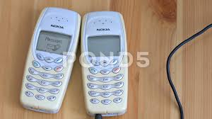 Two old Nokia 3410 Mobile phones on a ...