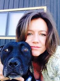 WHO IS THIS LADY? She is Penelope Evans Varn and she is a working Board  Member at OKANDOGS. One picture shows her out in the field tossing hay  bales and the other